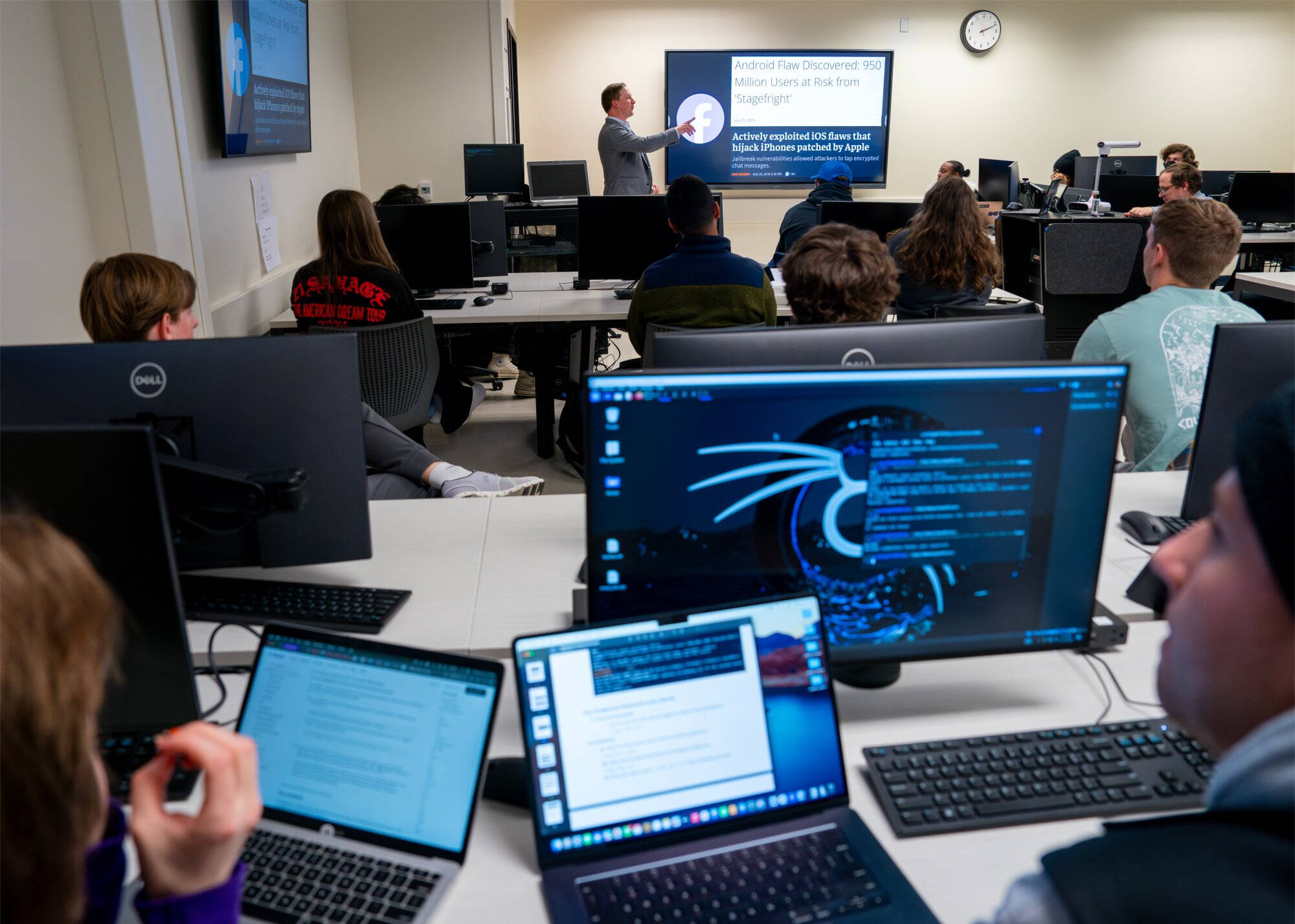 A group of students in a laboratory with their professor leading the session
